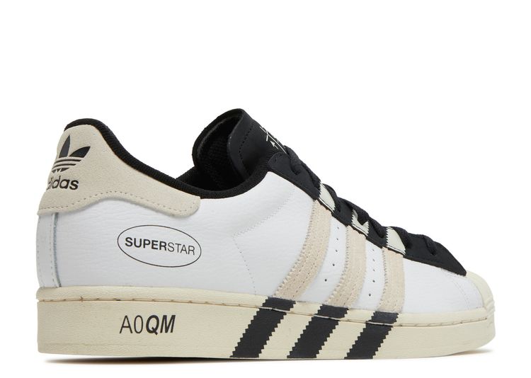 white adidas with black stripes on one side